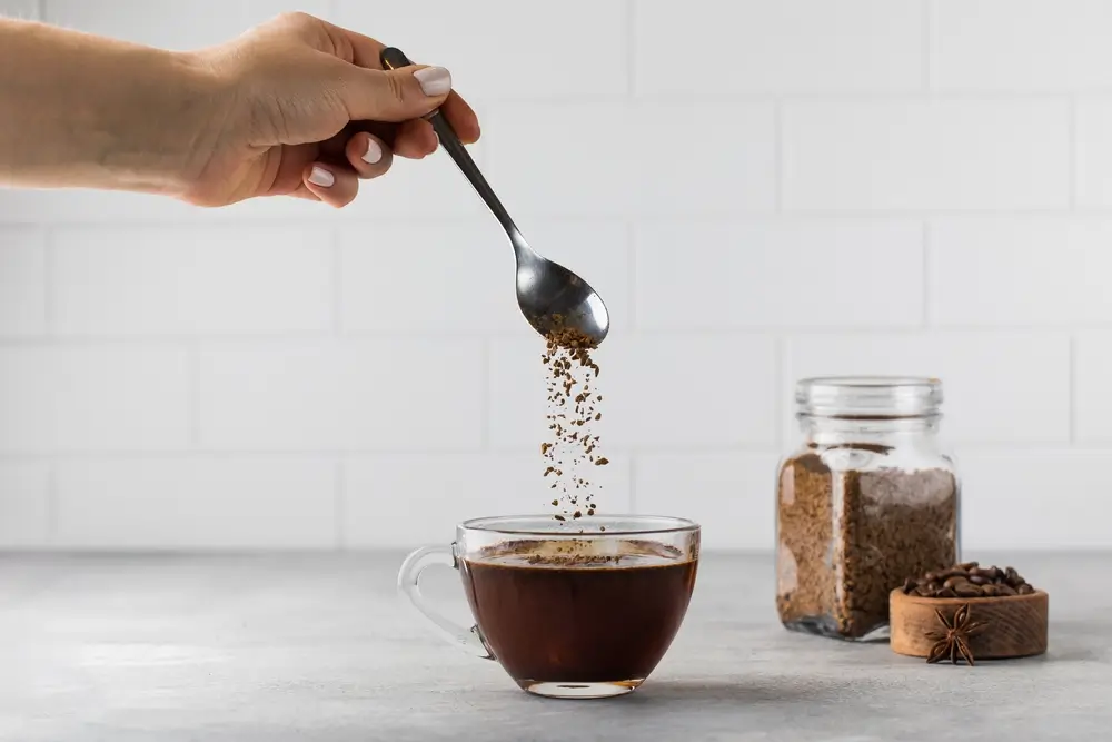 women using instant coffee to make a quick cup of coffee