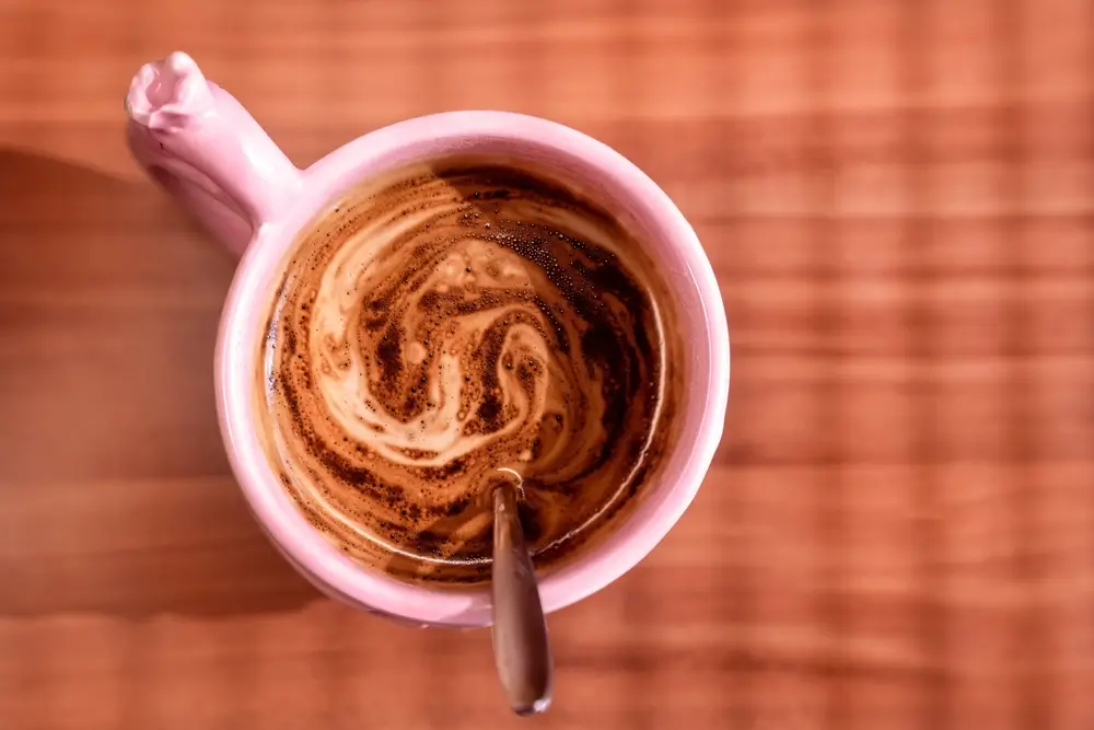 instant coffee made with milk in a pink cup