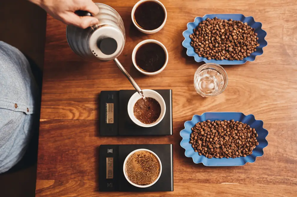 barista pouring coffee with single origin coffee placed on the table