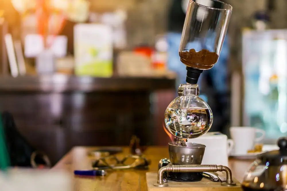 coffee being made by a barista by using the siphon coffee making method.